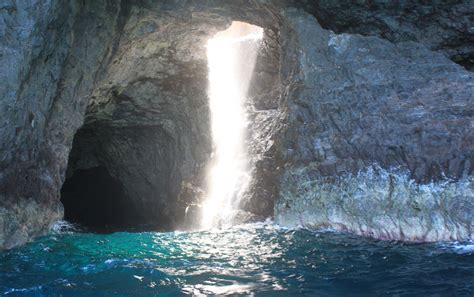 Sea Cave On Kauais Na Pali Coast Has A Hole In The Roof That Lets In