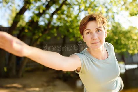 Mature Woman Practicing Yoga Outdoor Exercise On The Beach Near The River Stock Image Image
