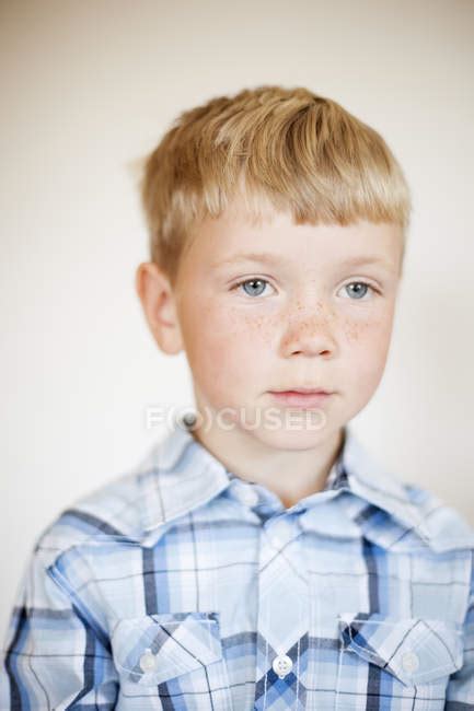 Portrait Of Blond Boy With Freckles Against Wall At Home — Elementary