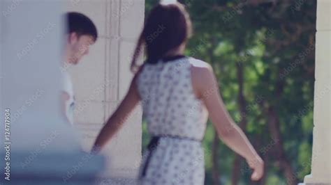 Slowmotion Couple In Love Goes Hand In Hand The Guy And The Girl Walk