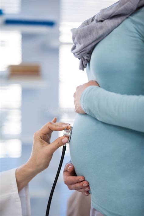 Doctor Examining Pregnant Woman With A Stethoscope Stock Photo Image