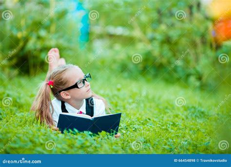 Adorable Little Girl Reading A Book Outdoors Stock Photo Image Of