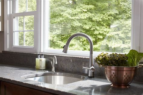 Sleek Faucet And Stainless Steel Sink In A Modern Kitchen With Grey