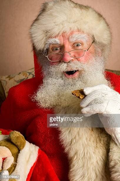 Santa Eating A Cookie Photos And Premium High Res Pictures Getty Images