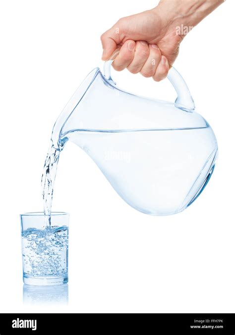 Water Poured From The Pitcher Into A Glass Isolated On The White