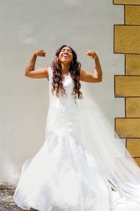 Beautiful African American Bride Standing In White Gown And Showing Her