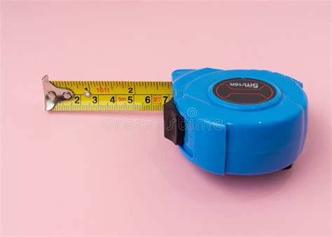 Measuring Tape With Centimeters And Inches On Pink Background Stock