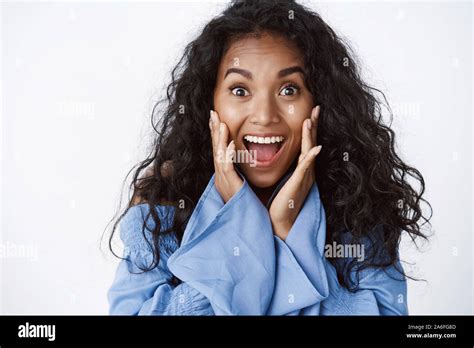 Surprised And Glad Enthusiastic African American Curly Haired Woman In