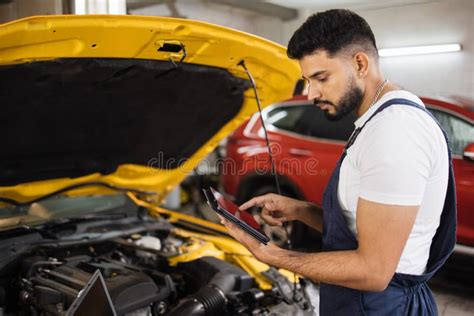 Serious Focused Man Car Technician Mechanic Repairing Car Problem Of