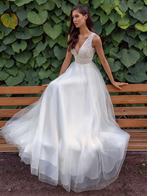 A Line Wedding Dress With A Deep V Neckline Lace Bodice And Illusion Back
