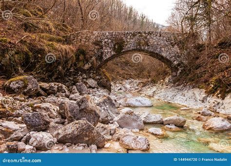 Old Stone Bridge Across Small Stream In The Woods Stock Photo Image