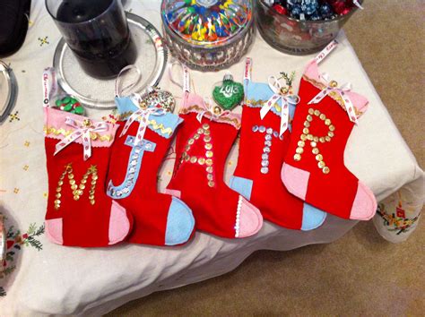 Four Stockings Are On A Table With Candy