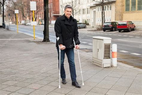 Man Walking With Crutches
