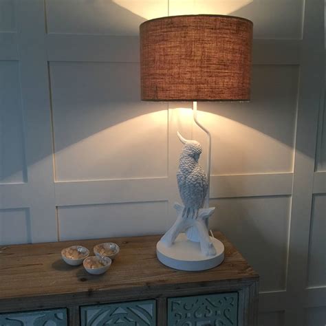 White drum lamp shade with decorative finial. White Parrot Bird Table Lamp And Hessian Drum Shade By Cowshed Interiors | notonthehighstreet.com