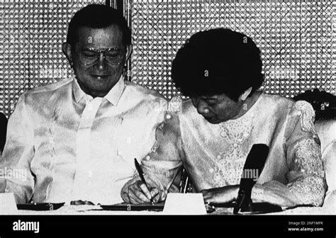 Philippines President Corazon Aquino Signs The New Constitution As Vice