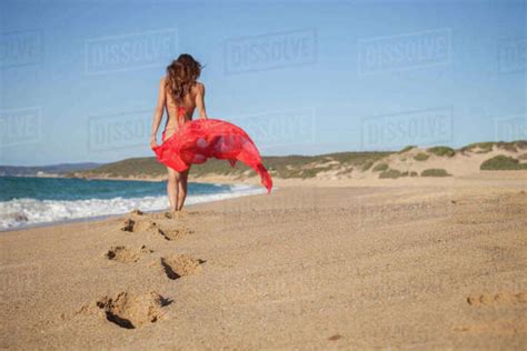 Woman On Beach Carrying Sarong Piscinas Sardinia Italy Stock Photo