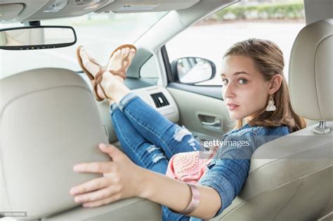 Teenage Girl Waiting In Passenger Seat Of Car Feet Up High Res Stock