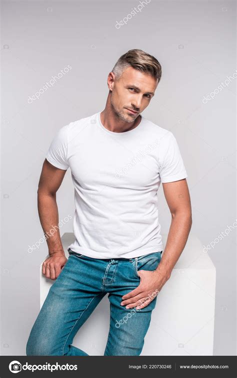 Portrait Handsome Man Denim Pants White Shirt Sitting Looking Camera Stock Photo