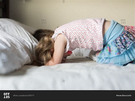 Babe Girl Wearing A Blue Skirt Lying In Bed Stock Photo OFFSET