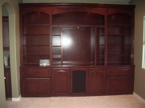 It is basically book shelves and bottom cabinet. Custom built in wall unit | C & L Design Specialists Inc