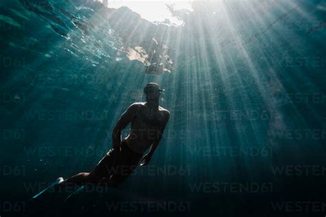 Full Length Of A Man Swimming Underwater In The Ocean Cavf