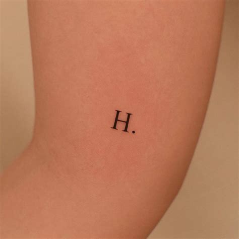 Letter H Tattooed On The Inner Arm