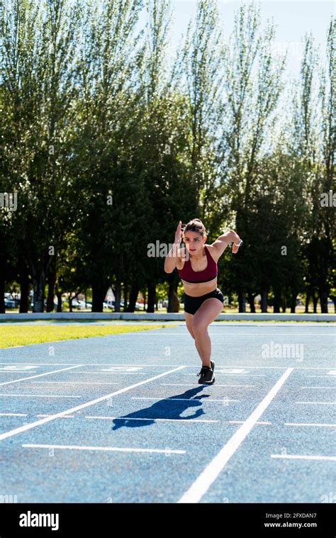 Athletic Woman Sprinting On Track Stock Photo Alamy