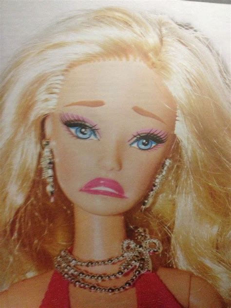 a close up of a barbie doll with blonde hair and blue eyes wearing necklaces