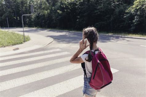 girl with backpack going to school and talking on the phone stock image image of concept