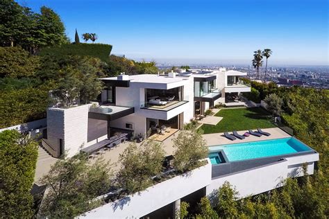 An Aerial View Of A House With A Pool In The Foreground