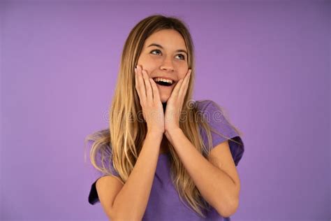 Surprised Woman Looking Up And Holding Cheeks With Hands Stock Image