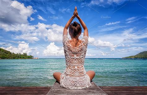 Young Beautiful Healthy Woman Making Meditation On The Beach High