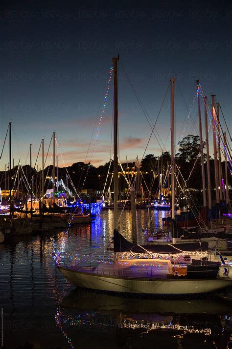 Boats In A Harbor Decorated With Lights For Christmas By Stocksy Contributor Carolyn