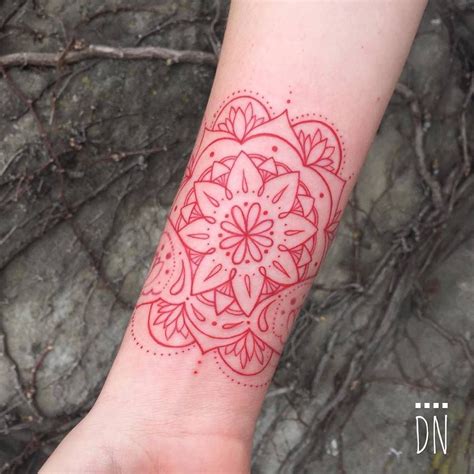 Professional temporary tattoos used in movie industry. Red infinity mandala tattoo on Jen's right inner wrist ...