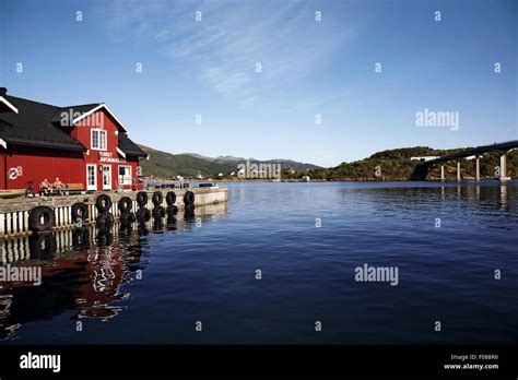 View Of Wooden Red House On Pier Overlooking Fjord In Norway Stock