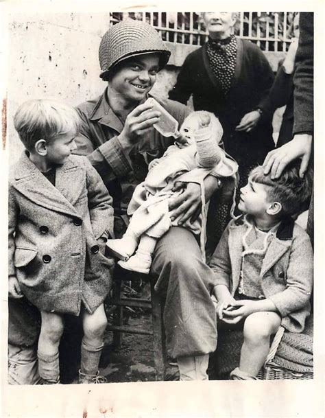 Us Soldier Feeds A Bottle To A Baby Girl Who Was Among A Group Of