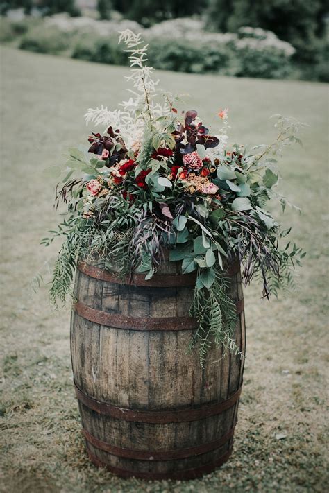 Wine Barrels With Lush Florals As A Dramatic Entrance For The Ceremony