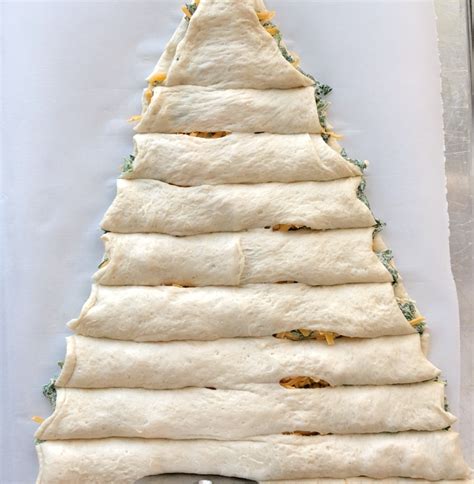 Unroll both pastry sheets onto baking tray, and use a pizza cutter or knife to cut a christmas tree shape into the dough; Christmas tree spinach dip breadsticks - It's Always Autumn
