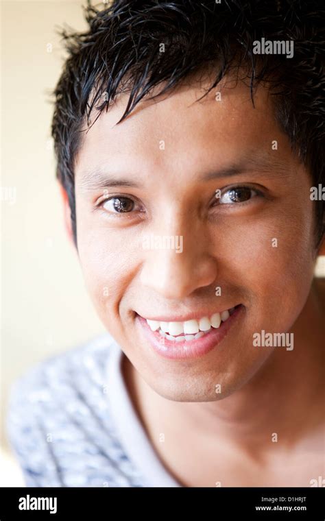 A Young Latino Man In His Mid Twenties Has A Bright Smile And Cheerful