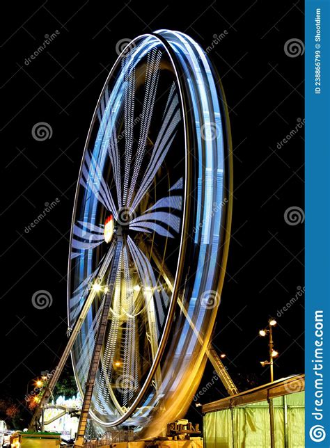 Brightly Colored Ferris Wheel Long Exposure In Amusement Park At Night