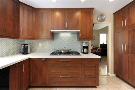 Rounded kitchen highlights light treated wooden cabinets with recessed lighting over dark tile floor. Wooden Kitchen Sets Inspiration - HomesFeed