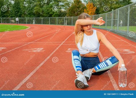 tired woman runner taking a rest after run sitting on the running stock image image of