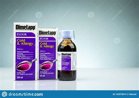 Dimetapp Elixir In Amber Bottle With Measuring Cup And