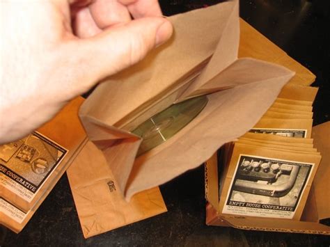 What's even cooler then that? empty house...: DMC's DIY paper lunch bag CD covers...