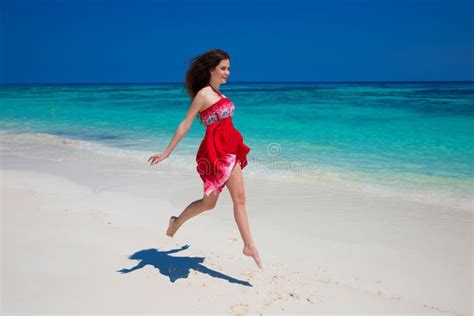 beautiful smiling girl running on exotic beach with white sand a stock image image of model