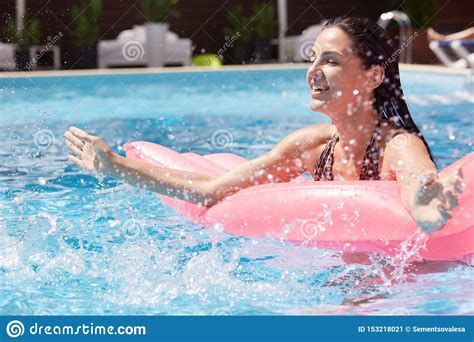 Outdoor Picture Of Relaxed Playful Female Having Fun In Swimming Pool