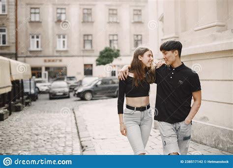 Two Lovers Hug On The Streets Of The Old City During A Date Stock Photo