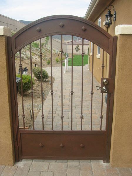 A freshly painted metal gate makes the exterior of a property look well maintained. iron gates paint colors - Google Search | Wrought iron gates, Iron gates, House front gate
