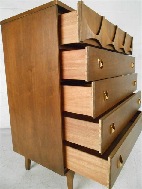 A gorgeous bedroom set that includes a dresser with mirror, highboy dresser, and small dresser. Mid-Century Modern Brasilia Bedroom Set by Broyhill at 1stdibs