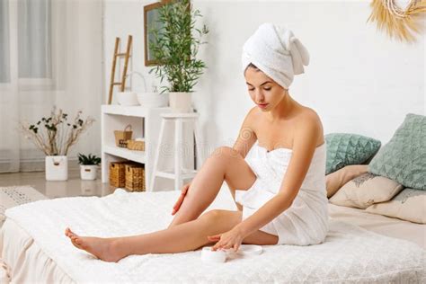woman applying cream on her legs stock image image of cute bedroom 161979035